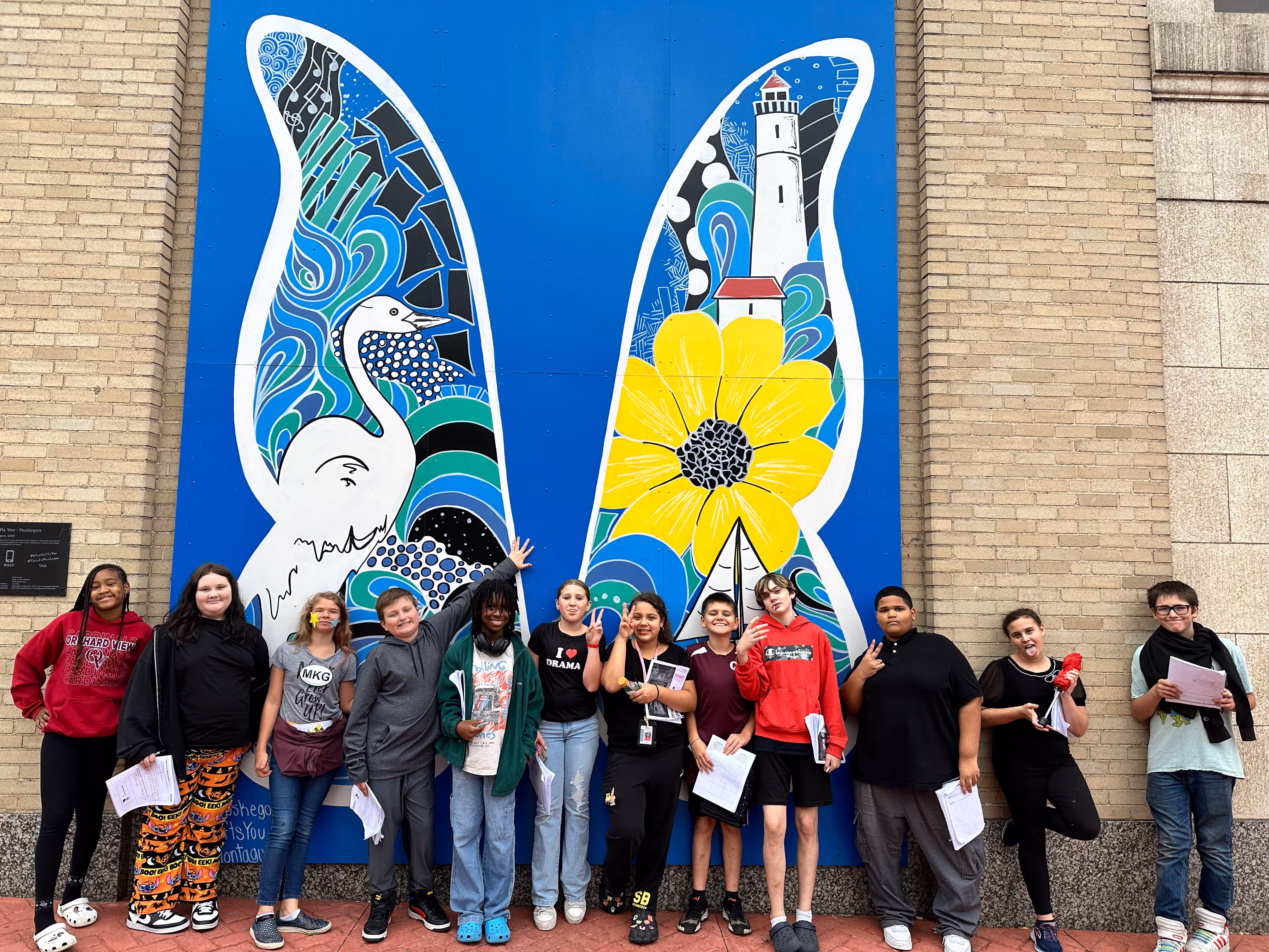 Students involved in Third Coast Learning Collaborative at Orchard View Middle School posing in front of a wall mural